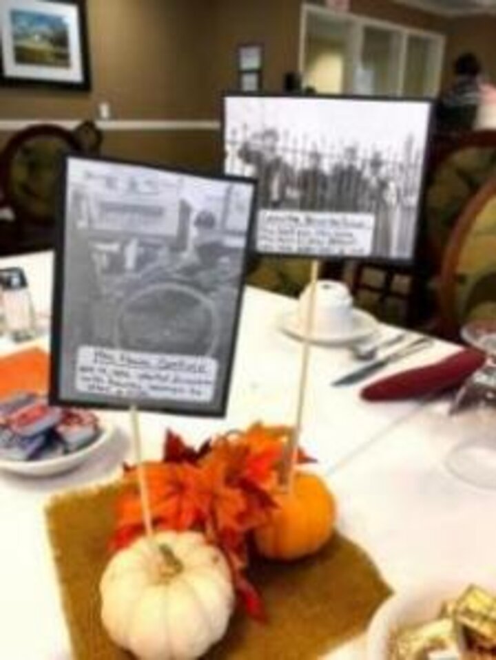 Two small pumpkins with historic photos of UNL Women's Club sticking out of them.