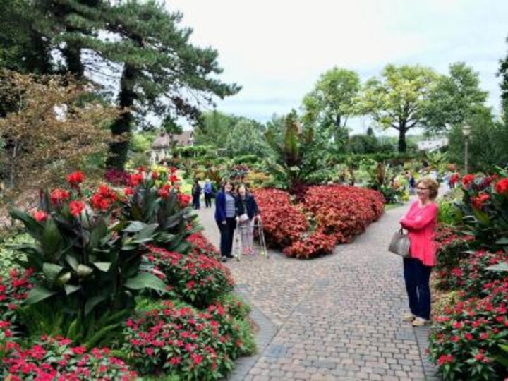 Women's Club members walk the paths of the Sunken Garden viewing the beautiful flowers.