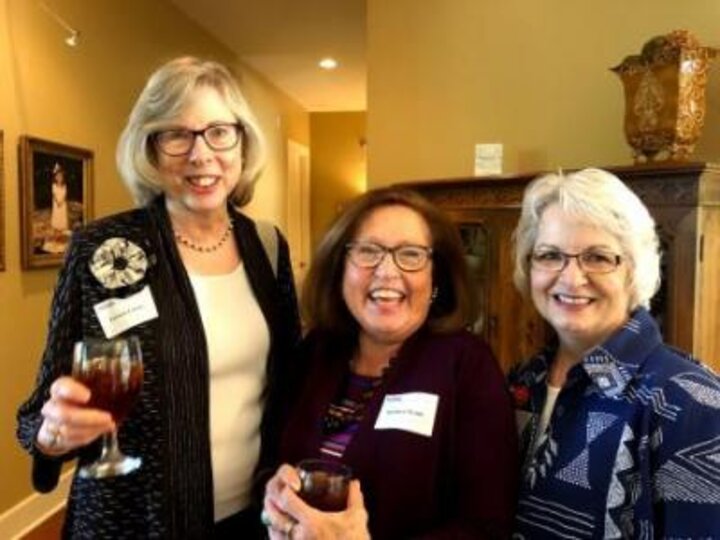 Three Women's Club members cheers at Hank and Susie Bounds house.