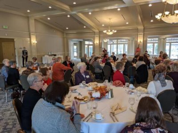 Club members listen to speaker at podium at Lincoln Country Club