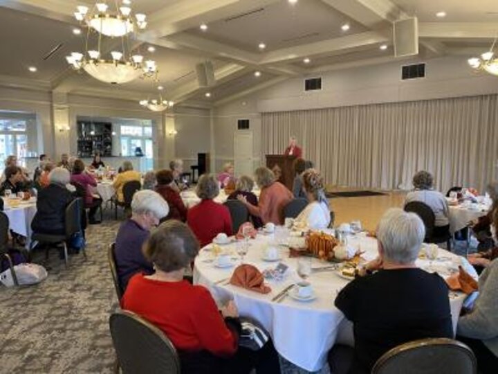 Club members listen to speaker at podium at Lincoln Country Club