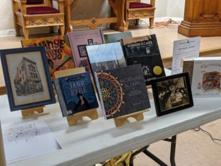 A table filled with books and pictures on display.