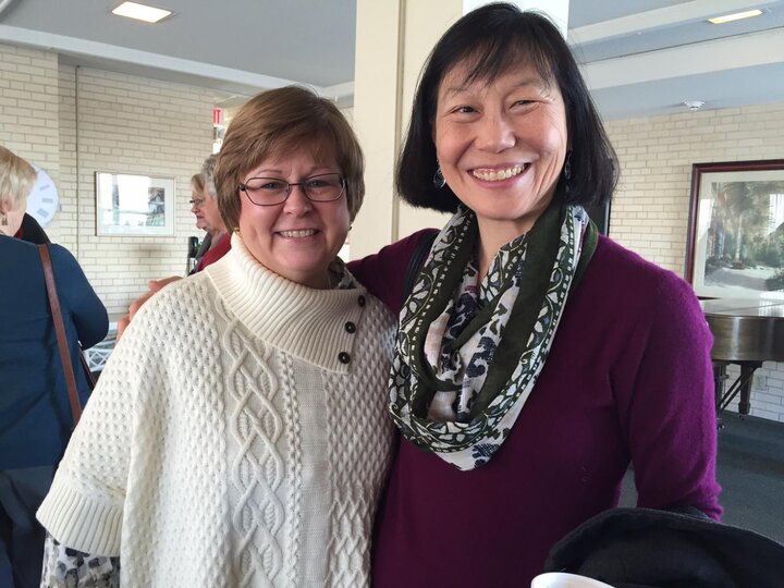 Two women smile at Spring 2016 luncheon.