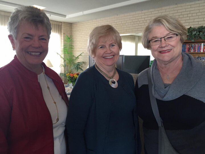 Three women smile at camera during 2016 spring luncheon.