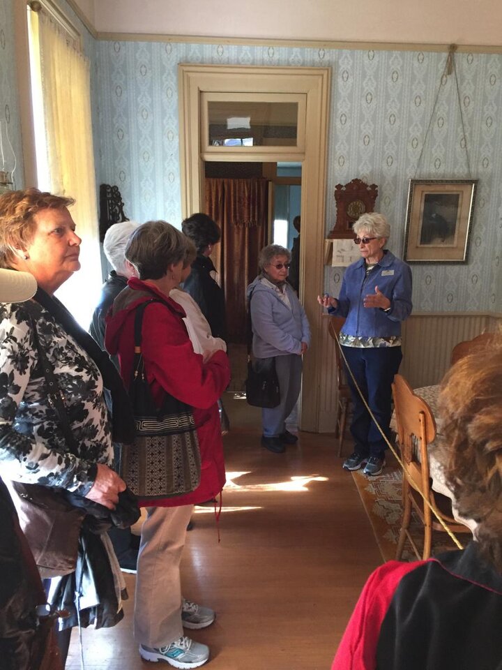 Tour Guide speaks to Women's Group inside Willa Cather's house.