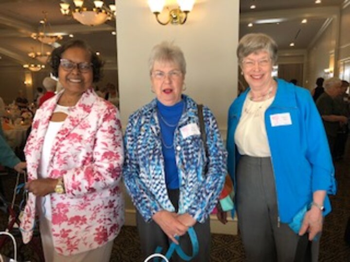 Three women pose for photo at Spring Luncheon and style show.
