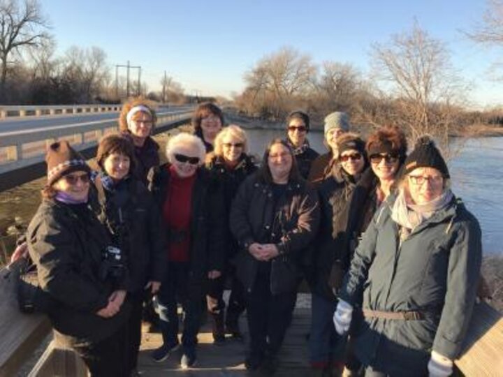 Twelve members of Women's Club pose in front of river near Kearney