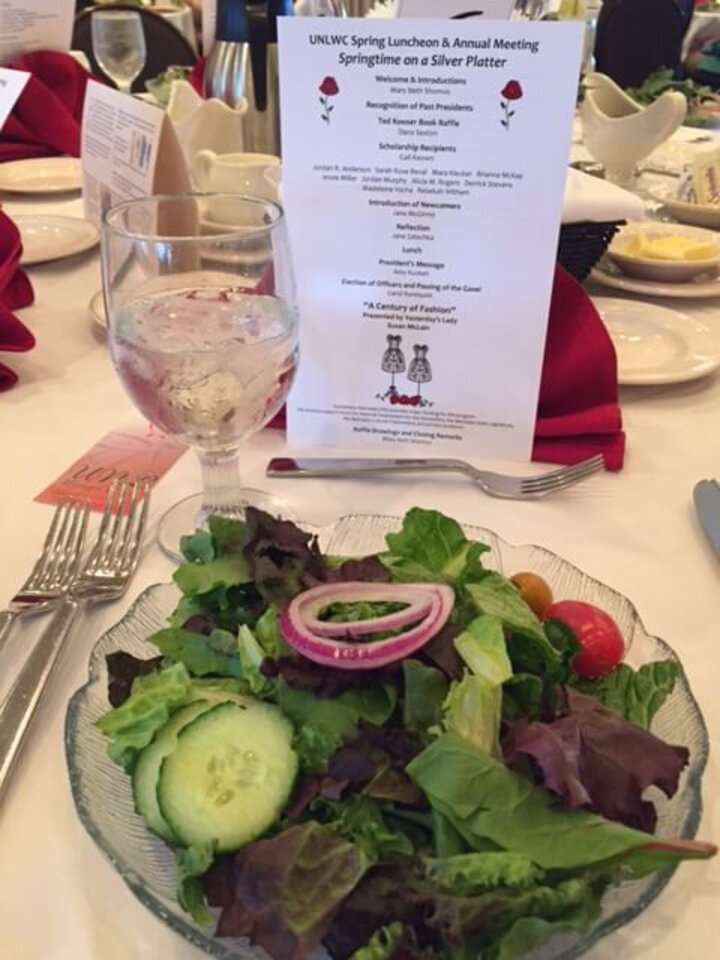 Close up of salad and event itinerary. 
